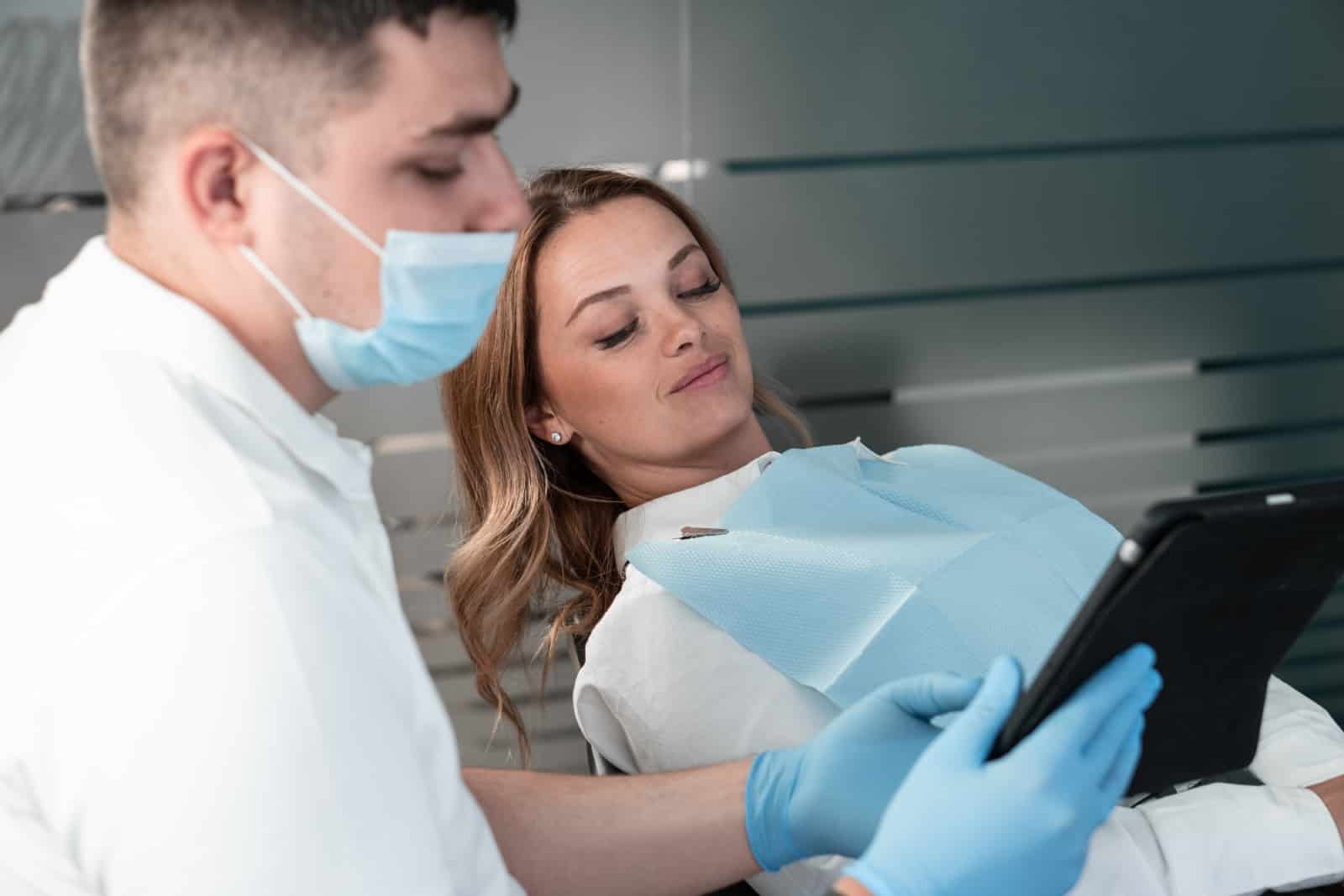 About Brisbane emergency dentist discussing a treatment plan with a patient during a dental consultation.