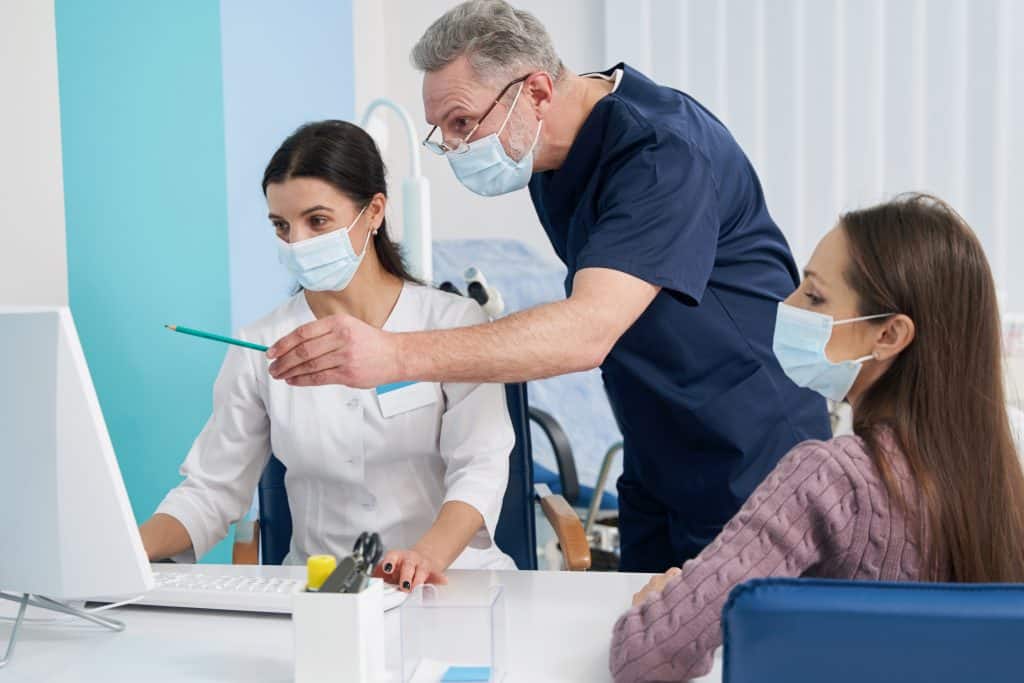 dentist is showing patient's dental condition who came to the dental clinic by searching "dental clinic near me".